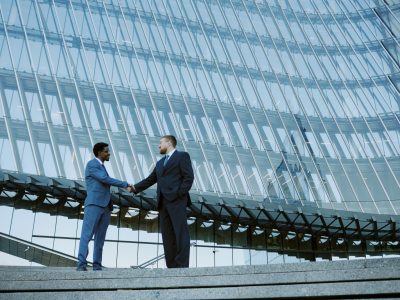 Shaking Hands in Corporate Glass Building